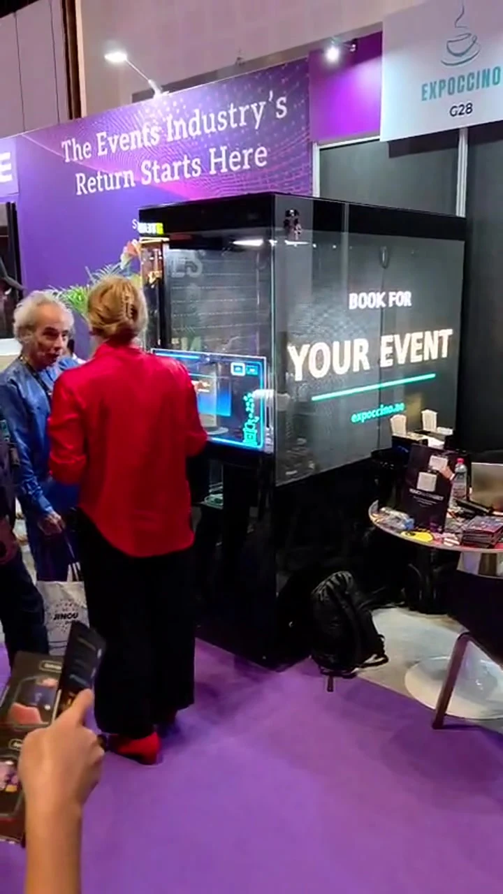 Visitors beside Brio at an exhibition