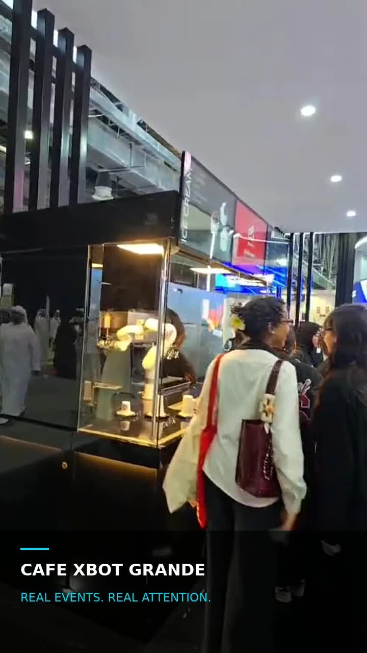 Visitors gathered around Cafe Xbot Grande at an exhibition