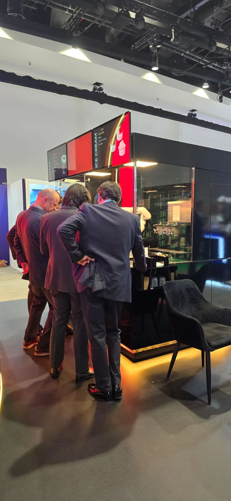Conversations beside Cafe Xbot Grande at an exhibition