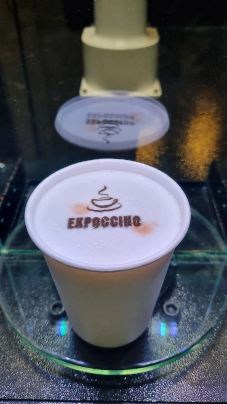 Expoccino logo printed on the milk foam of a coffee